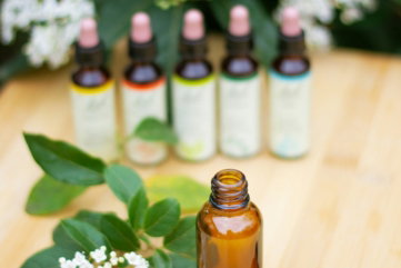 a wooden table topped with bottles of essential oils